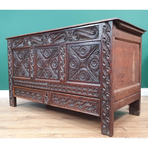 441 - An Antique and later carved oak Mule Chest, the lift up lid above carved leafage and scrolled frieze... 