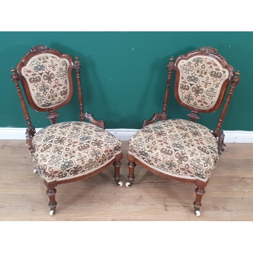 446 - A pair of Victorian carved walnut Nursing Chairs with upholstered backs and seats, the back with tur... 