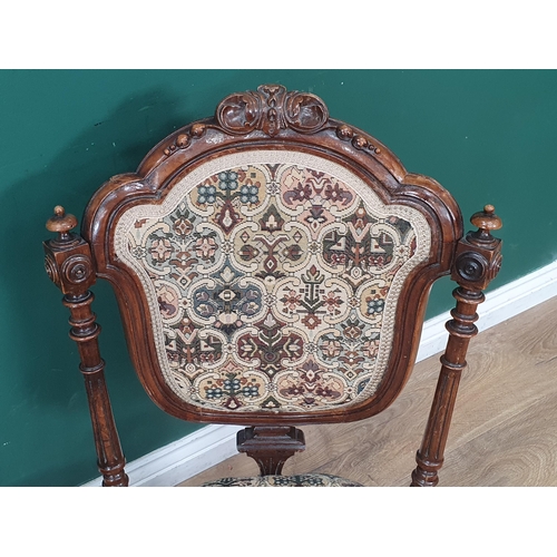 446 - A pair of Victorian carved walnut Nursing Chairs with upholstered backs and seats, the back with tur... 