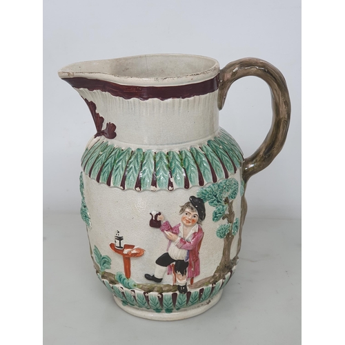 460 - A Teapot, the lid with bud finial, the body with two oval panels with moulded figure decorations wit... 