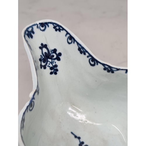 466 - A Liverpool c.1770 porcelain Sauceboat with shaped handle, moulded scrolled and leafage designs, wit... 