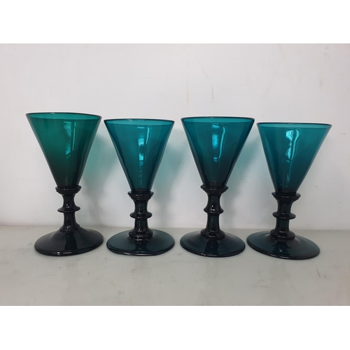 469 - Eight green glass Wine Glasses with conical bowls on single knop stems, 4 1/2in, one with ground rim