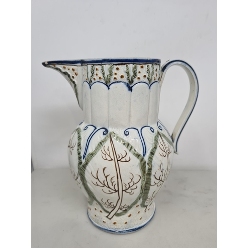 482 - A large 19th Century moulded Prattware Jug depicting hunting scene, A/F, 8in H, another Prattware Ju... 