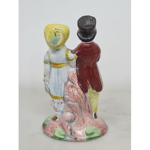 485 - A pearlware Staffordshire figure of the 'Dandies', the well-dressed couple in coats and hats, standi... 