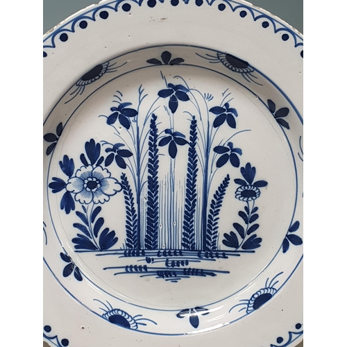 487 - An 18th Century blue and white Delft Charger with designs of sprays of flowers and repeat border des... 