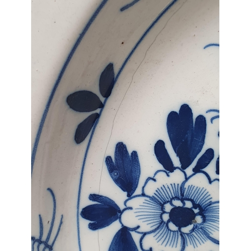 487 - An 18th Century blue and white Delft Charger with designs of sprays of flowers and repeat border des... 