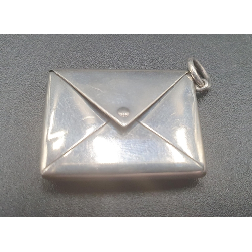 49 - An Edward VII silver Pendant Stamp Case in the form of a miniature envelope embossed with head of Ed... 