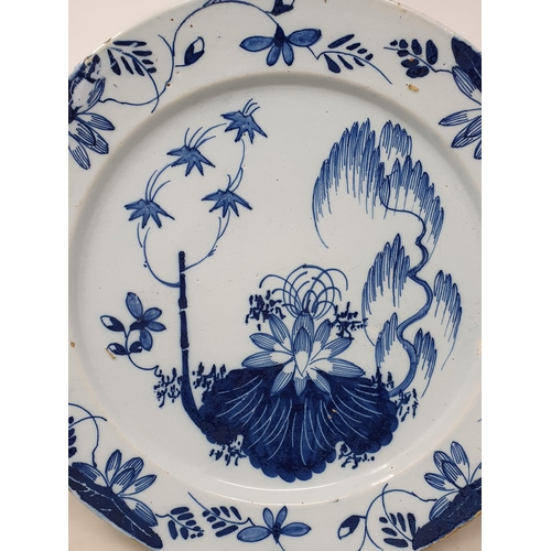 502 - An 18th Century blue and white Delft Charger with floral design rim, the centre with stylised floral... 