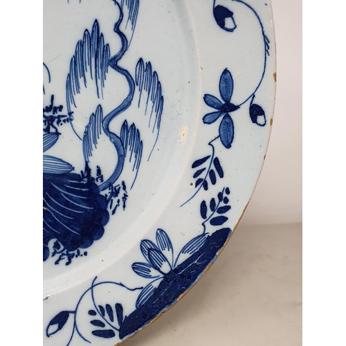 502 - An 18th Century blue and white Delft Charger with floral design rim, the centre with stylised floral... 