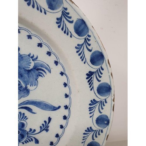 503 - An 18th Century blue and white Bowl/Charger with stylised border, the centre with floral designs and... 