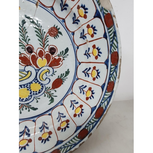 506 - A large antique Delft Bowl with floral multi borders, the centre with stylised floral decorations (A... 