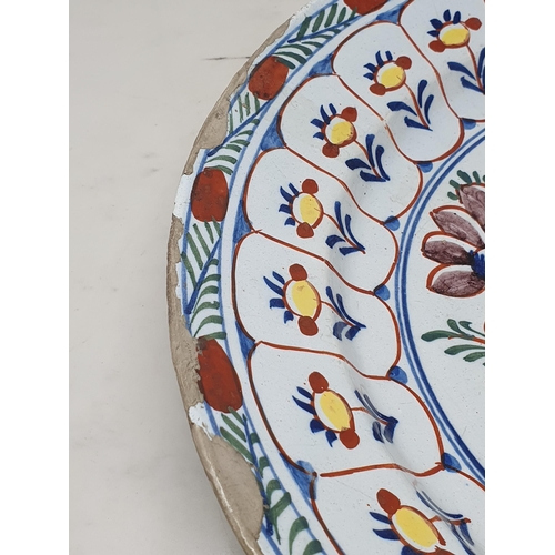 506 - A large antique Delft Bowl with floral multi borders, the centre with stylised floral decorations (A... 