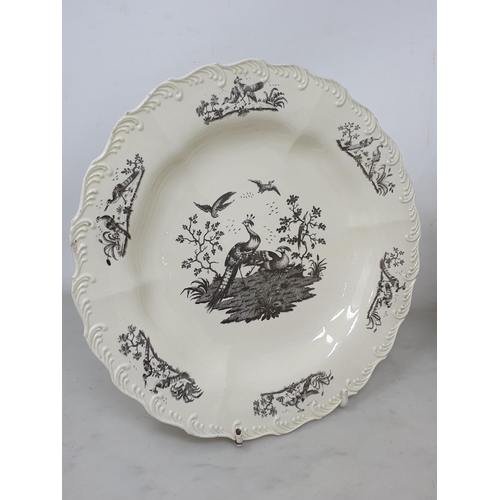 512 - A creamware Plate of oval form with pierced basket weave rim, the centre decorated with peafowl in l... 