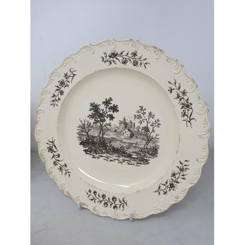 512 - A creamware Plate of oval form with pierced basket weave rim, the centre decorated with peafowl in l... 