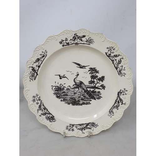 512 - A creamware Plate of oval form with pierced basket weave rim, the centre decorated with peafowl in l... 