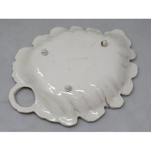 513 - A 'Leeds Pottery' leaf shaped Dish with pierced handle and raised on three squat bun supports, A/F, ... 