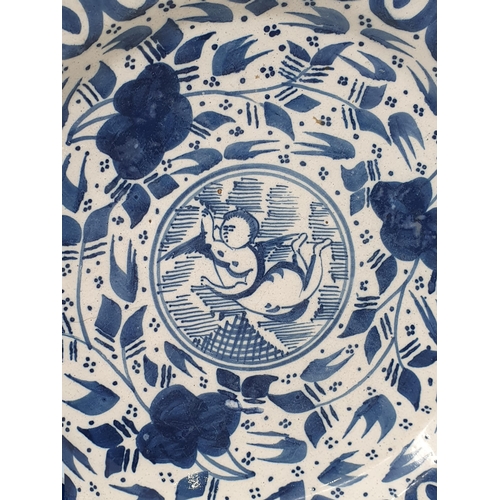 519 - An antique blue and white Delft Plate/Dish with multi borders and stylised floral sprays, the centre... 