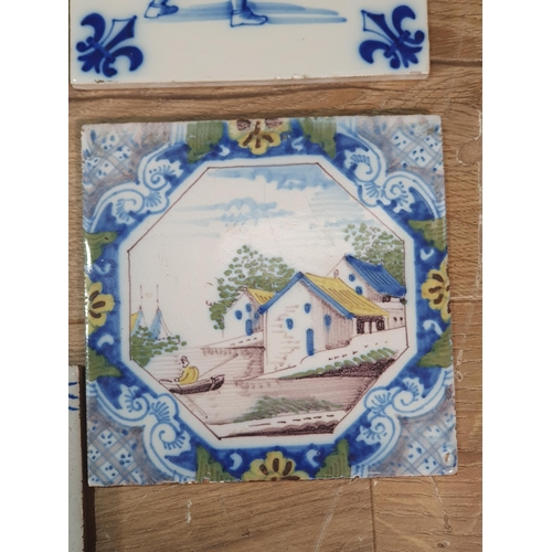 520 - A collection of Delft and other tiles including two floral decorated Dutch tiles, a set of six blue ... 