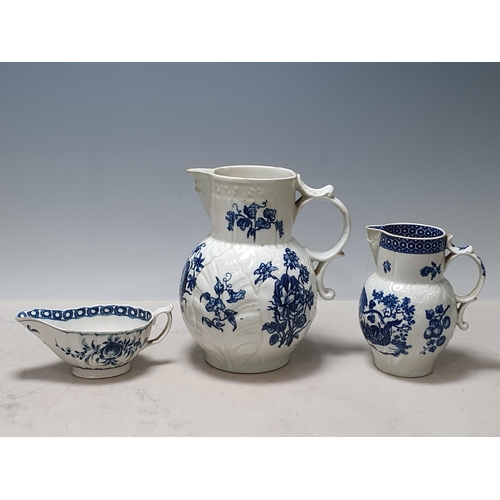 531 - A Worcester Cabbage Leaf Mask Jug decorated blue and white flowers, 8in H, restored, another, simila... 