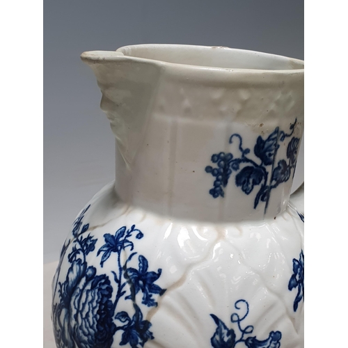 531 - A Worcester Cabbage Leaf Mask Jug decorated blue and white flowers, 8in H, restored, another, simila... 