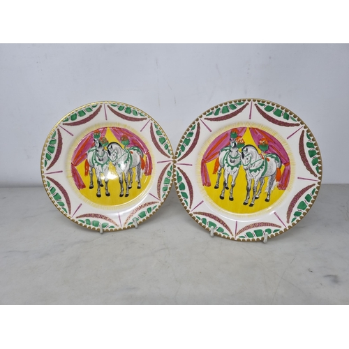 537 - A pair of Clarice Cliff Bizarre Plates, two figures of white Horses, dressed plumes on yellow ground... 