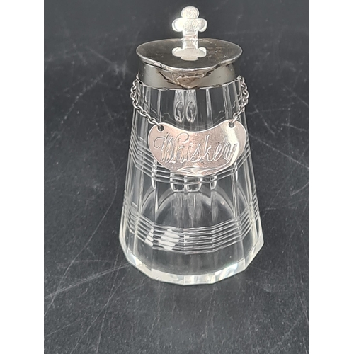 59 - A George V silver lidded cut glass Toddy Flask and a Whiskey Label, Birmingham 1926