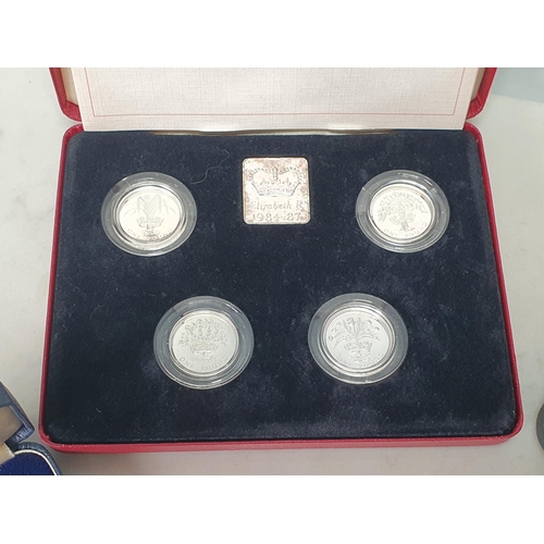 592 - A Royal Mint silver Proof 1984-1987 One Pound Coin four-piece set, along with a Papua New Guinea 197... 