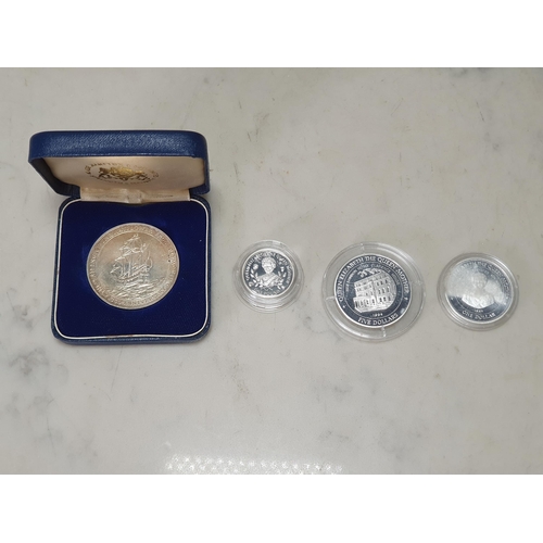 592 - A Royal Mint silver Proof 1984-1987 One Pound Coin four-piece set, along with a Papua New Guinea 197... 