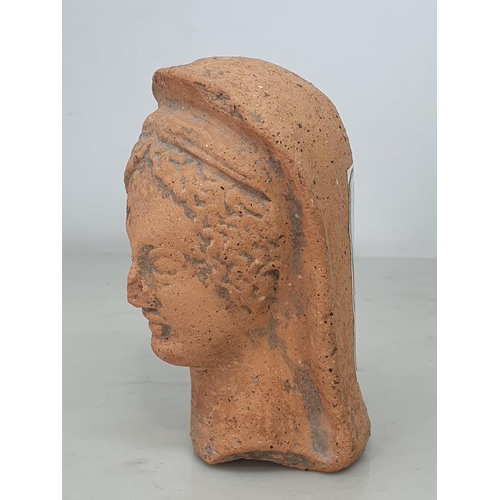 596 - A small Roman Terracotta Bust of a Lady wearing headdress, broken off at the lower neck, bearing old... 