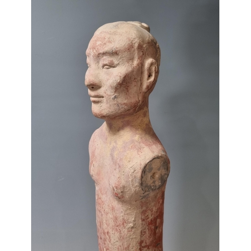 597 - A Chinese clay/terracotta Standing Figure of a Man (possibly Han Dynasty), with wooden bracket suppo... 