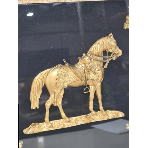 605 - A 19th Century gilt metal relief picture in the form of a horse with fruiting vine corner decoration... 