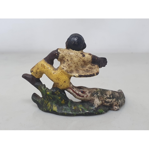 606 - A 1930's cast metal painted Bottle Opener in the form of a boy being bitten by a crocodile, probably... 