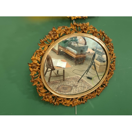 608 - A pair of gilt metal oval Wall Mirrors with cast and pierced floral borders, 1ft 8in H