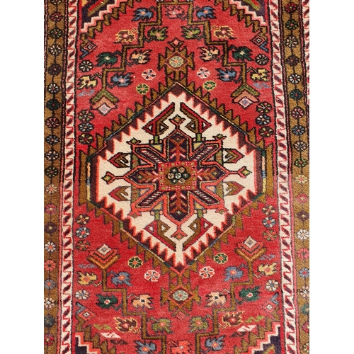 631 - A Persian/Iranian Runner, with floral multi borders, the centre with geometric design motifs and sty... 