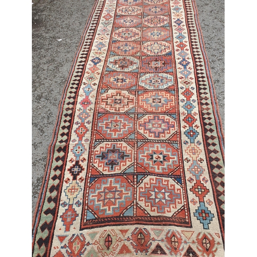 632 - An antique  bordered Shirvan Runner, the central field with two rows of thirteen guls with latch hoo... 