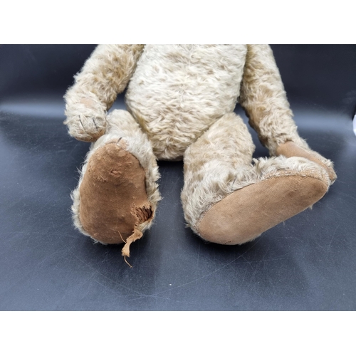 649 - An early 20th Century Teddy Bear by J F Klarner with original pads, pointed snout, 25in