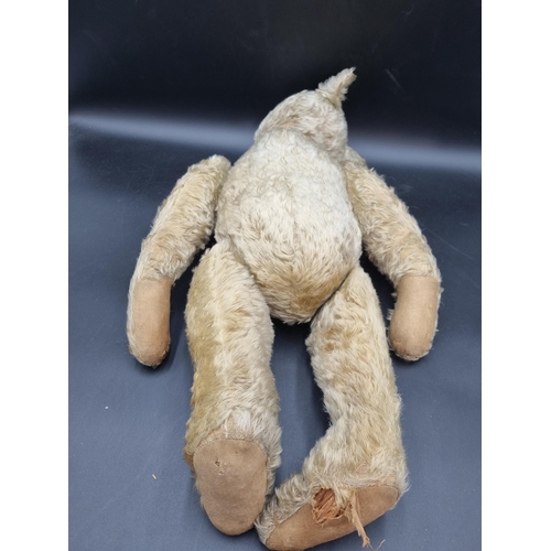 649 - An early 20th Century Teddy Bear by J F Klarner with original pads, pointed snout, 25in