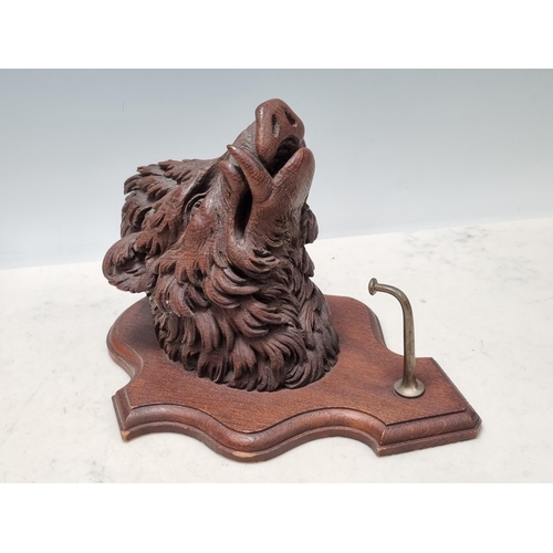 652 - A Black Forest style carved oak Boar Head on shield with coat hook 11in H