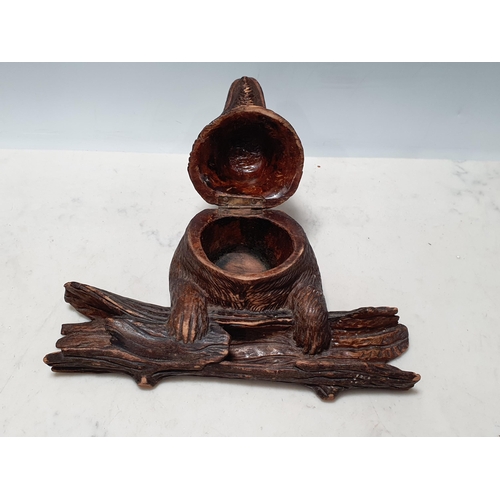 653 - A Black Forest carved Inkwell in the form of a bear holding a log 4 1/2in H