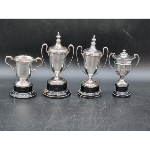 69 - A pair of George V small silver two handled Trophies and Covers, Birmingham 1929, and two other smal... 