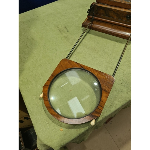 695 - A Victorian walnut Monoscope and Stereoscope Viewer, shows pictures in depth with magnifying glass a... 