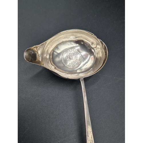 72 - A Georgian Toddy Ladle with coin inset oval bowl, spiral whalebone handle