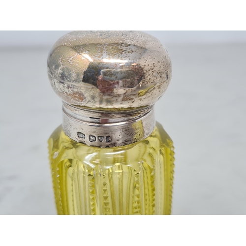 78 - An Edward VII silver lidded yellow glass Scent Bottle engraved initials, Chester 1908, and an opalin... 