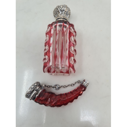 80 - A red cut glass Scent Bottle of horn shape with scroll embossed lid, and a red overlaid glass Scent ... 