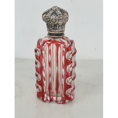 80 - A red cut glass Scent Bottle of horn shape with scroll embossed lid, and a red overlaid glass Scent ... 