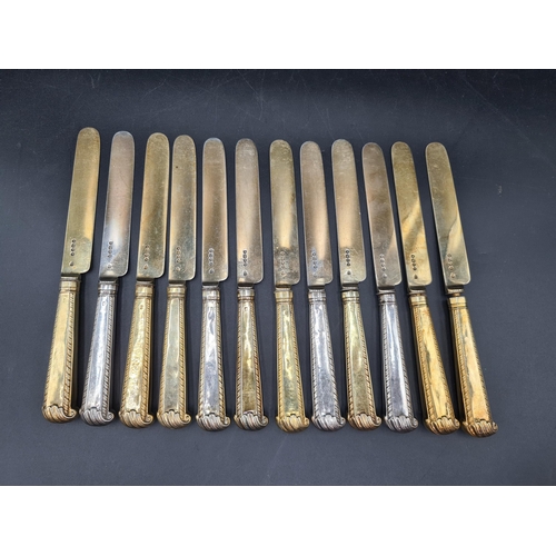 90 - A matched Set of silver-gilt Cutlery engraved bird crests, viz: 12 Table Spoons Onslow pattern, Lond... 