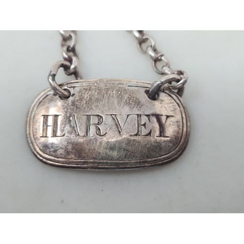 93 - A George IV silver Harvey Label, London 1821, maker: W.E, another Harvey Label and silver Scotch lab... 