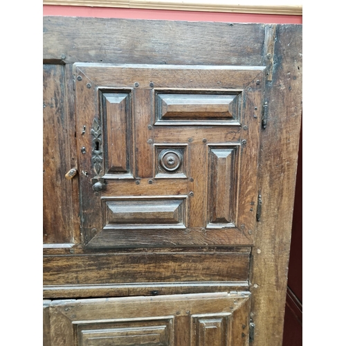 343 - An 18th Century oak Continental Cupboard having two pairs of cupboard doors with multiple panels abo... 