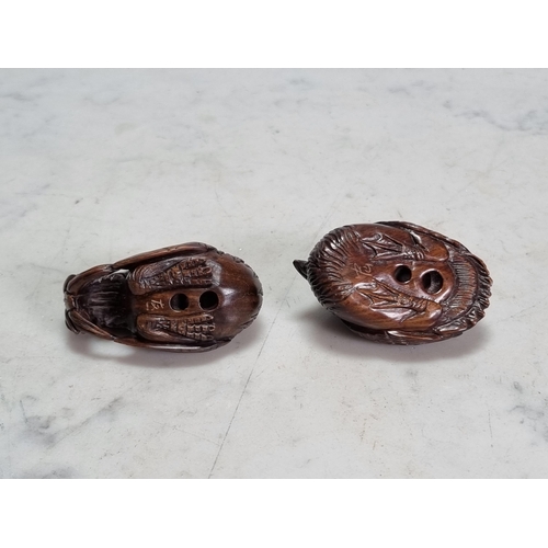 548 - Two Oriental carved wood Netsuke of a Jungle Fowl and a Pelican, 2in L bear signatures