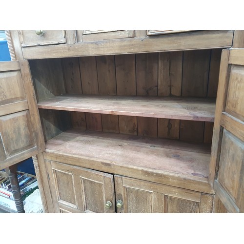 318 - An antique Irish pine Food Cupboard with an arrangement of drawers and cupboard doors and having mou... 